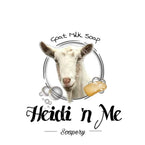 Heidi ‘n Me Soapery Goat Milk Soap shows a picture of a beautiful white goat die with a bar of soap and surrounded by soap bubbles.
